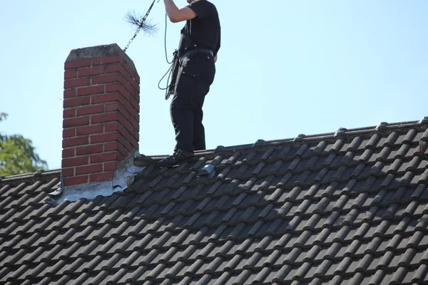 Technician cleaning a chimney